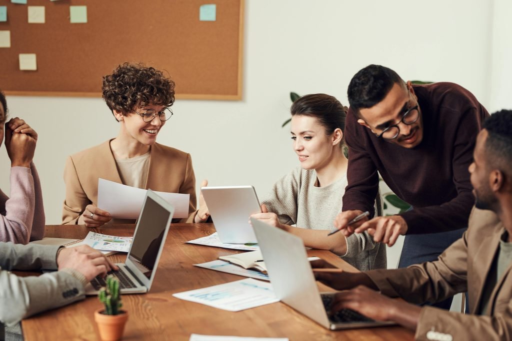 About A diverse group of professionals engaged in a collaborative office meeting, sharing ideas and discussing projects.
