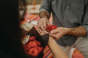 Close-up of a couple's engagement in Maras, Peru with a bouquet of roses.