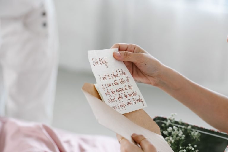 Close-up of a person reading a beautifully handwritten letter, evoking personal connection.